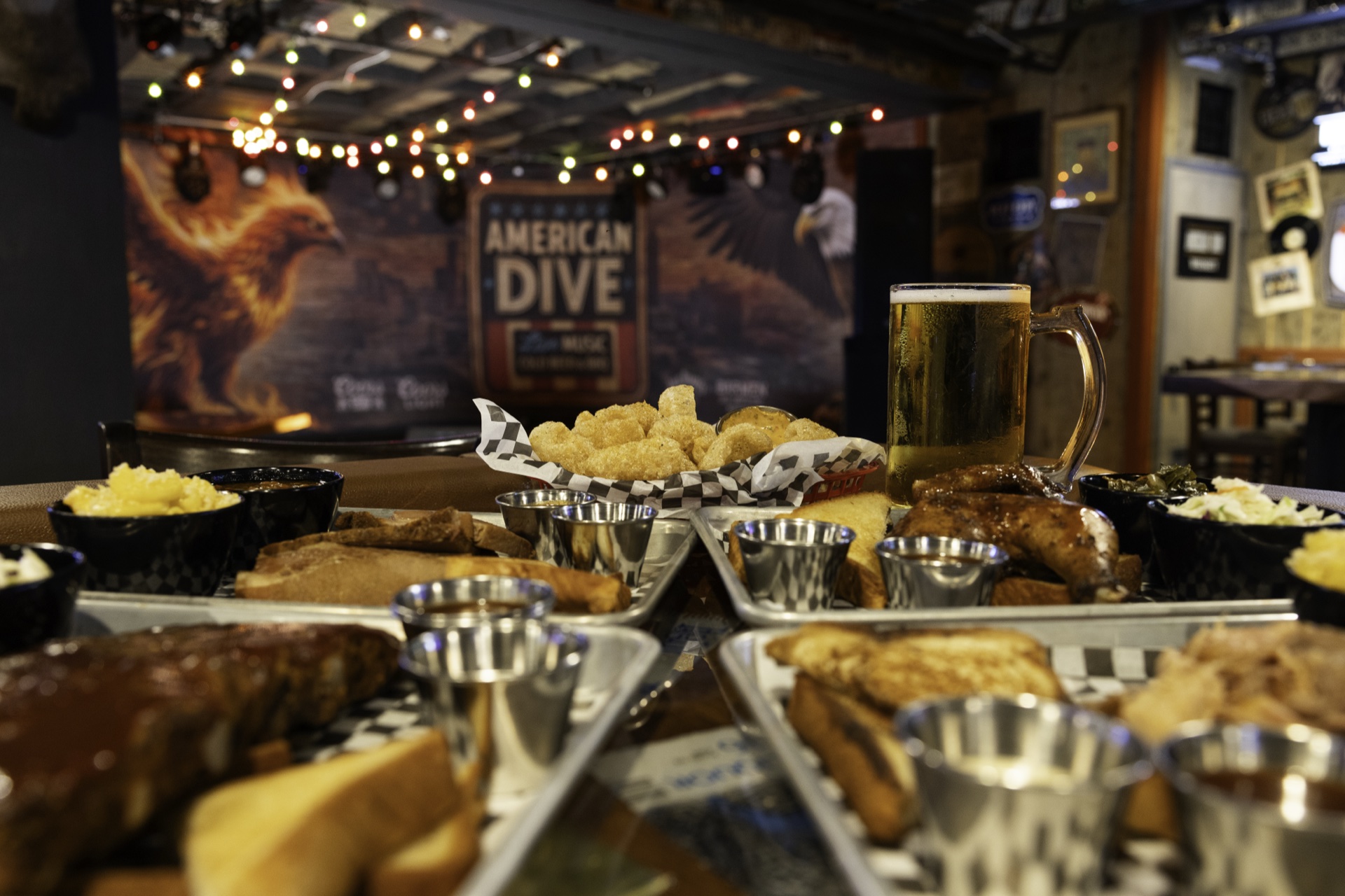 Barbecue, sides and a draft beer with the American Dive stage in the background.