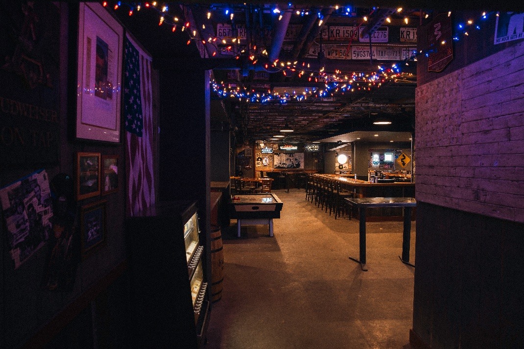 A view into American Dive beneath multicolored string lights.